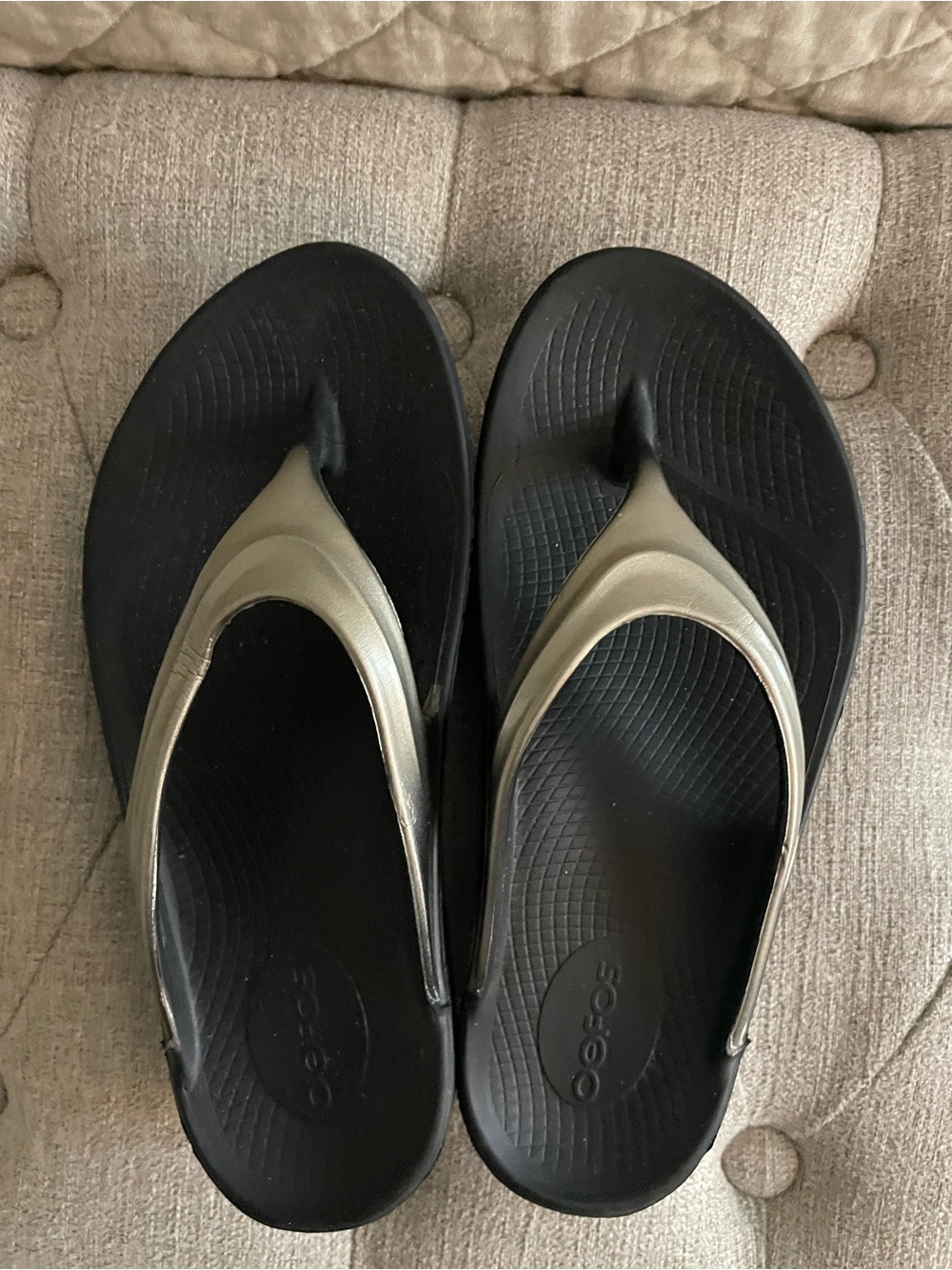 OOFOS Women's Black Flip Flops with Metallic Gold Straps